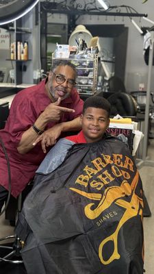 Barber and client after a fresh haircut at Frank's Barber & Beauty Salon in Seattle